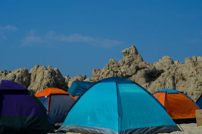 Low angle view of tent against blue sky