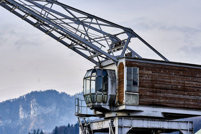 Low angle view of crane against sky