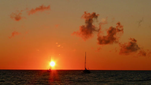 Scenic view of sea against orange sky