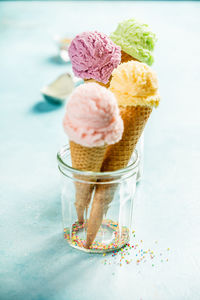 Close-up of ice cream cones in containers on table