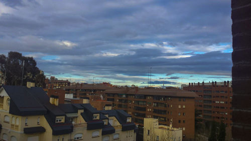 Buildings against cloudy sky