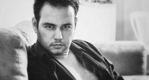 Portrait mature man sitting on sofa at home