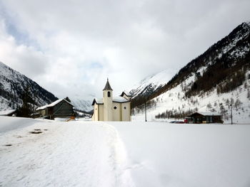 Panoramic view of church against sky during winter