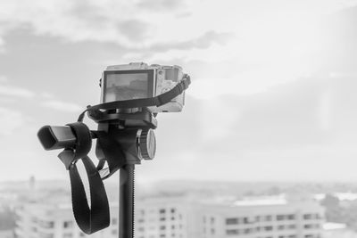 Close-up of camera against sky