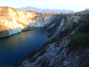 Scenic view of lake and mountains against sky