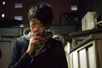 Close-up of man smoking indoors