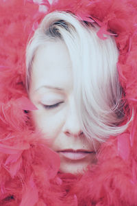 Close-up of young woman with pink petals