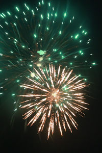 Low angle view of firework display at night
