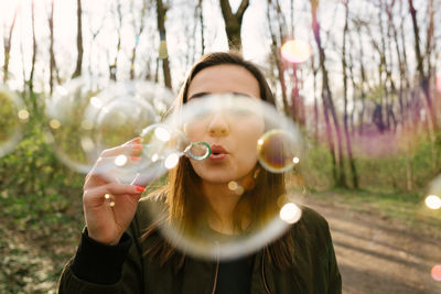 Portrait of woman holding bubbles