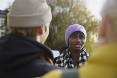 Smiling woman talking to friends