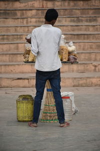 Rear view of man standing against wall