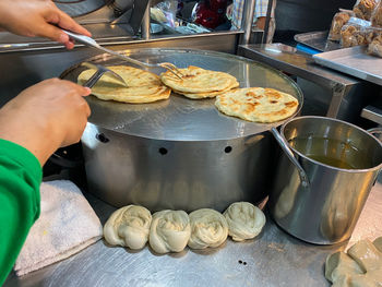 Midsection of person preparing food at market