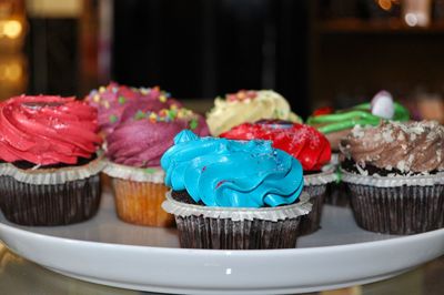 Close-up of colorful cupcakes in plate on table