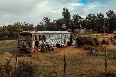 Abandoned truck on field against sky