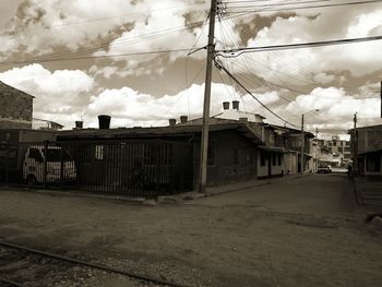 Houses in city against storm clouds