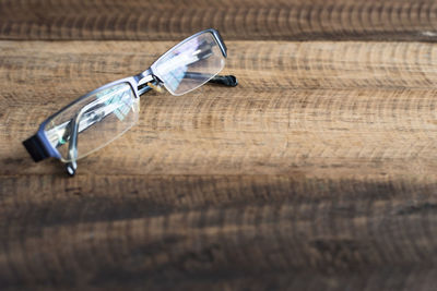 Close-up of eyeglasses on wooden table