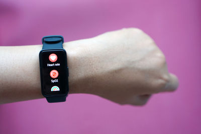 Cropped hand using mobile phone