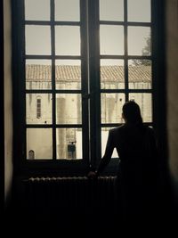 Woman looking through window