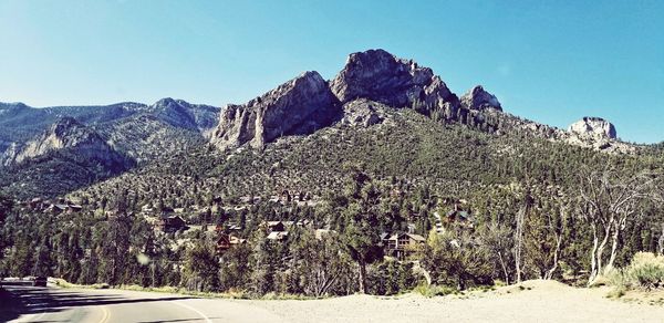 Scenic view of mountains against clear blue sky