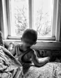 Boy playing on bed at home