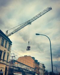 Low angle view of building against cloudy sky