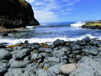 Rocks on beach against sky