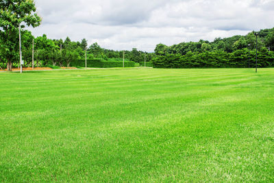 Scenic view of golf course against sky