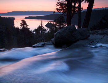 Scenic view of river against sky during sunset