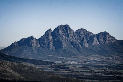 Scenic view of snowcapped mountains against clear sky