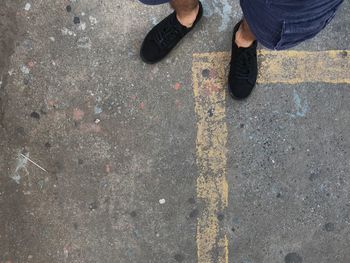 Low section of person standing on road