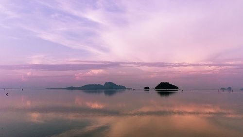 Scenic view of lake against sky at sunset