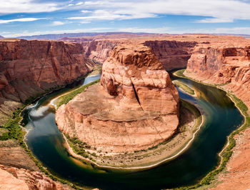 High angle view of horseshoe bend against cloudy sky