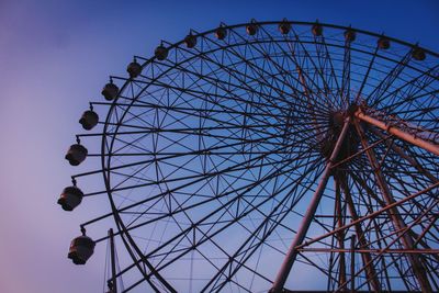 Low angle view of ferris wheel against sky