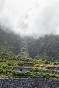 Scenic view of lake by mountains against sky