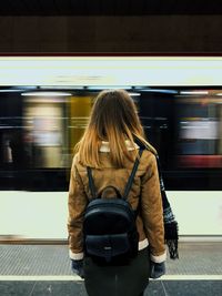 Rear view of woman on train at railroad station