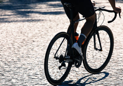 Low section of man cycling on street