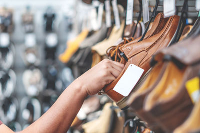 Close-up of hand holding cigarette at store