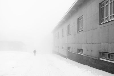 People skiing on snow covered landscape