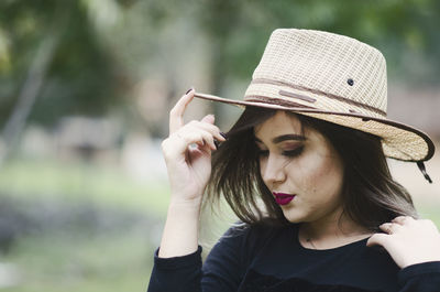 Portrait of beautiful young woman wearing hat