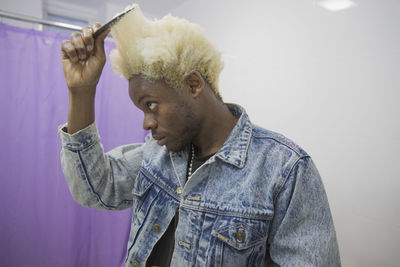 A young man styling his hair