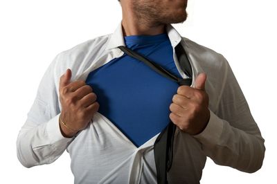 Midsection of man holding hands against white background