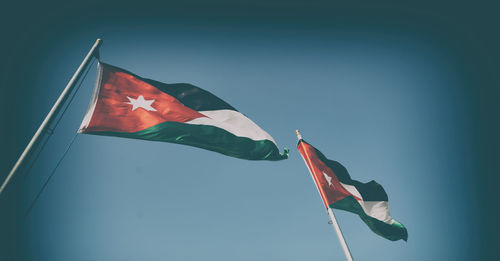 Low angle view of flag against sky