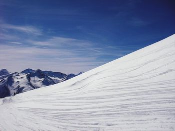 Scenic view of snow against blue sky