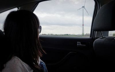 Rear view of woman in car