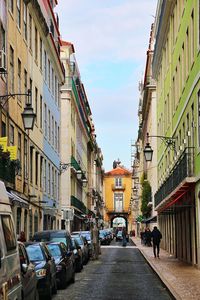 Street amidst buildings in city against sky