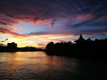 Scenic view of river against sky at sunset