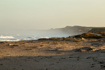 Scenic view of arid landscape against sky