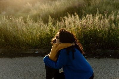 Mother hugging daughter