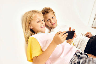 High angle view of mother and daughter against white background