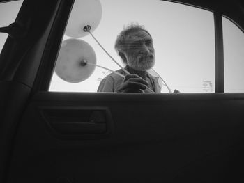 Portrait of man sitting in car